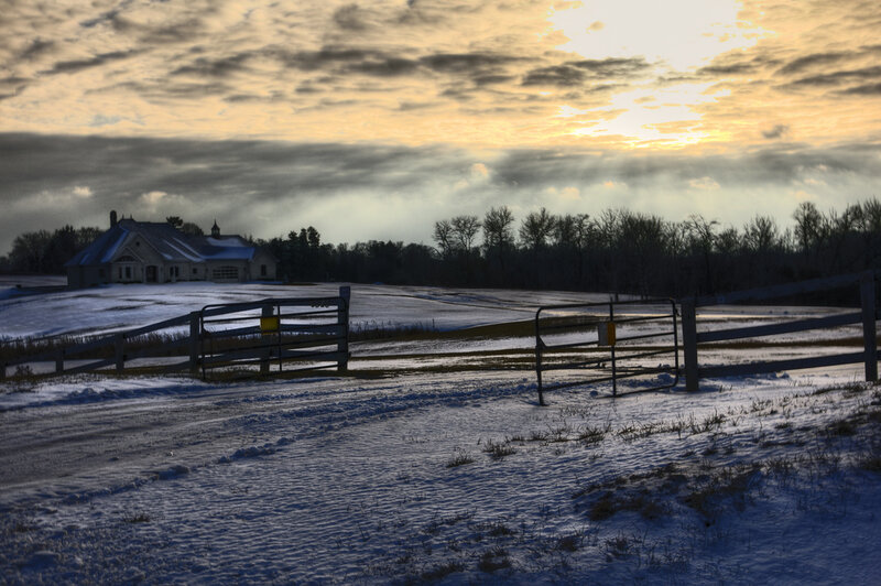 Snow-covered Farm at Sunset