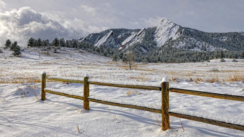 Snow-covered Fence and Mountains