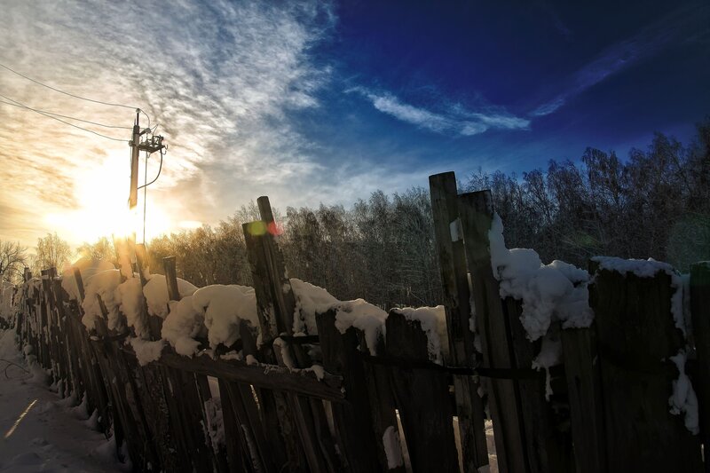 Snow-covered Fence at Sunset — Blue, Dramatic