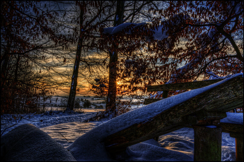 Snow-covered Fence at Sunset