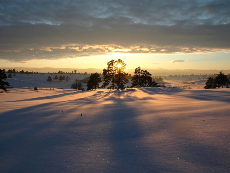 Snow-covered Field at Sunrise
