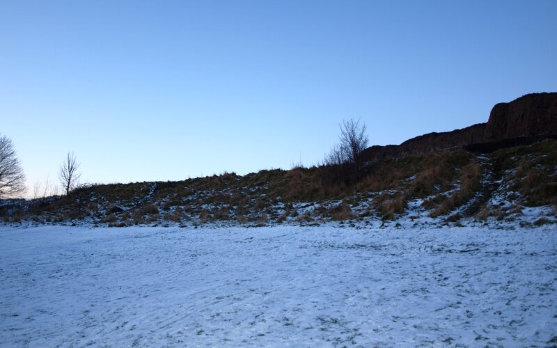 Snow-covered Field with Hill