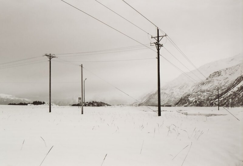 Snow-covered Field with Poles
