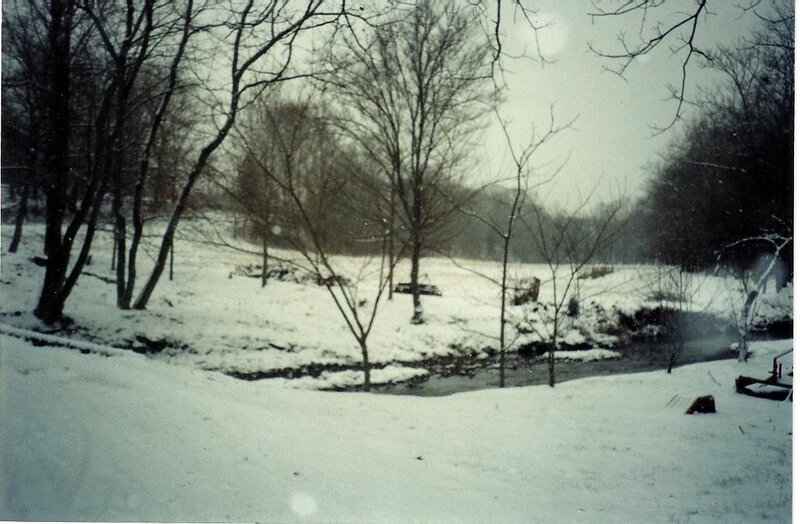 Snow-covered Field with Stream