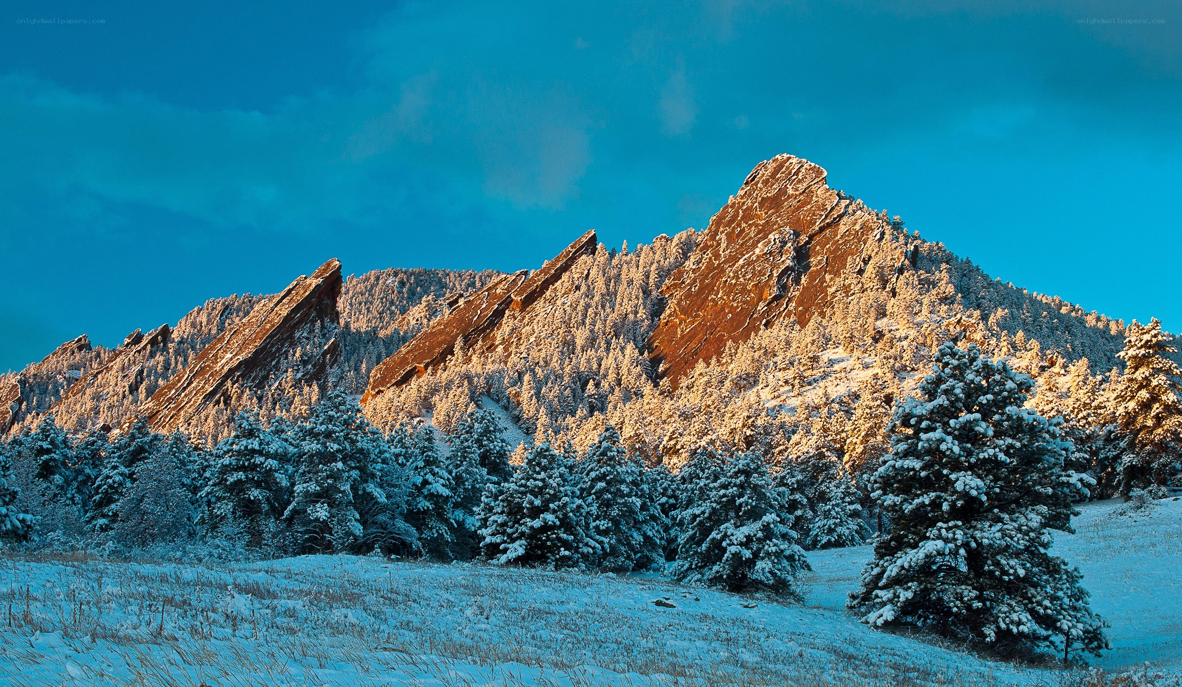 Snow-covered Flatirons at sunset