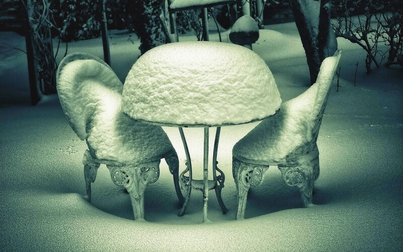 Snow-covered garden furniture
