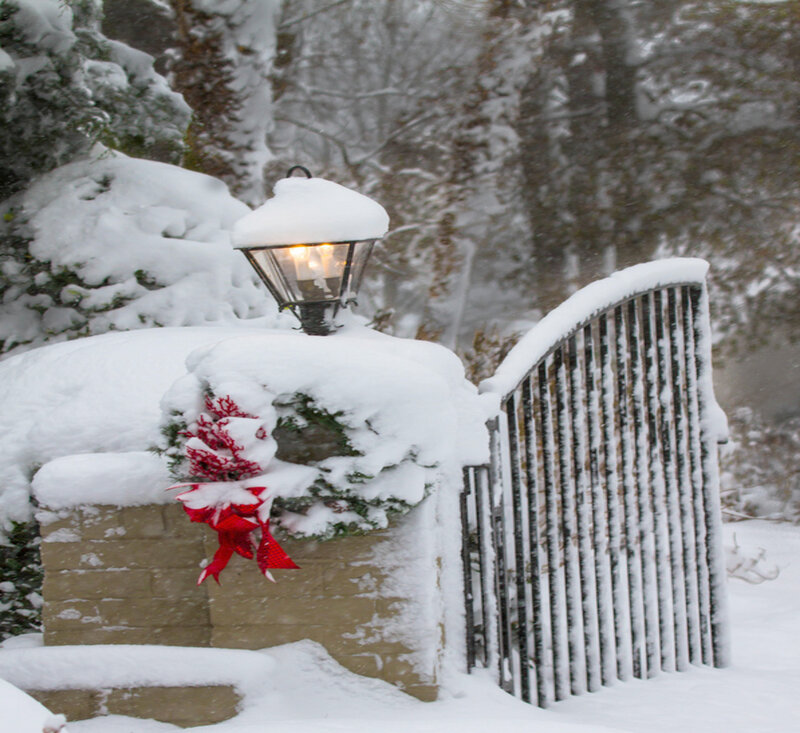 Snow-covered Gate with Lamp