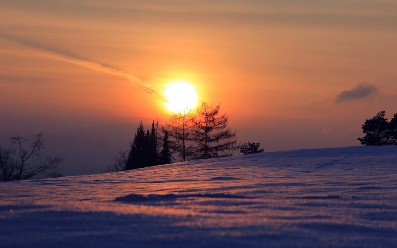 Snow-covered Hill at Sunset