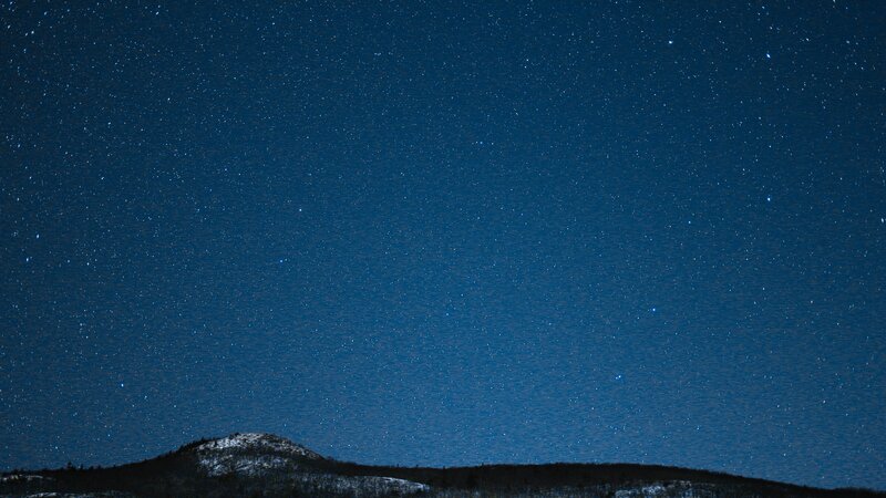 Snow-covered Hill under Stars