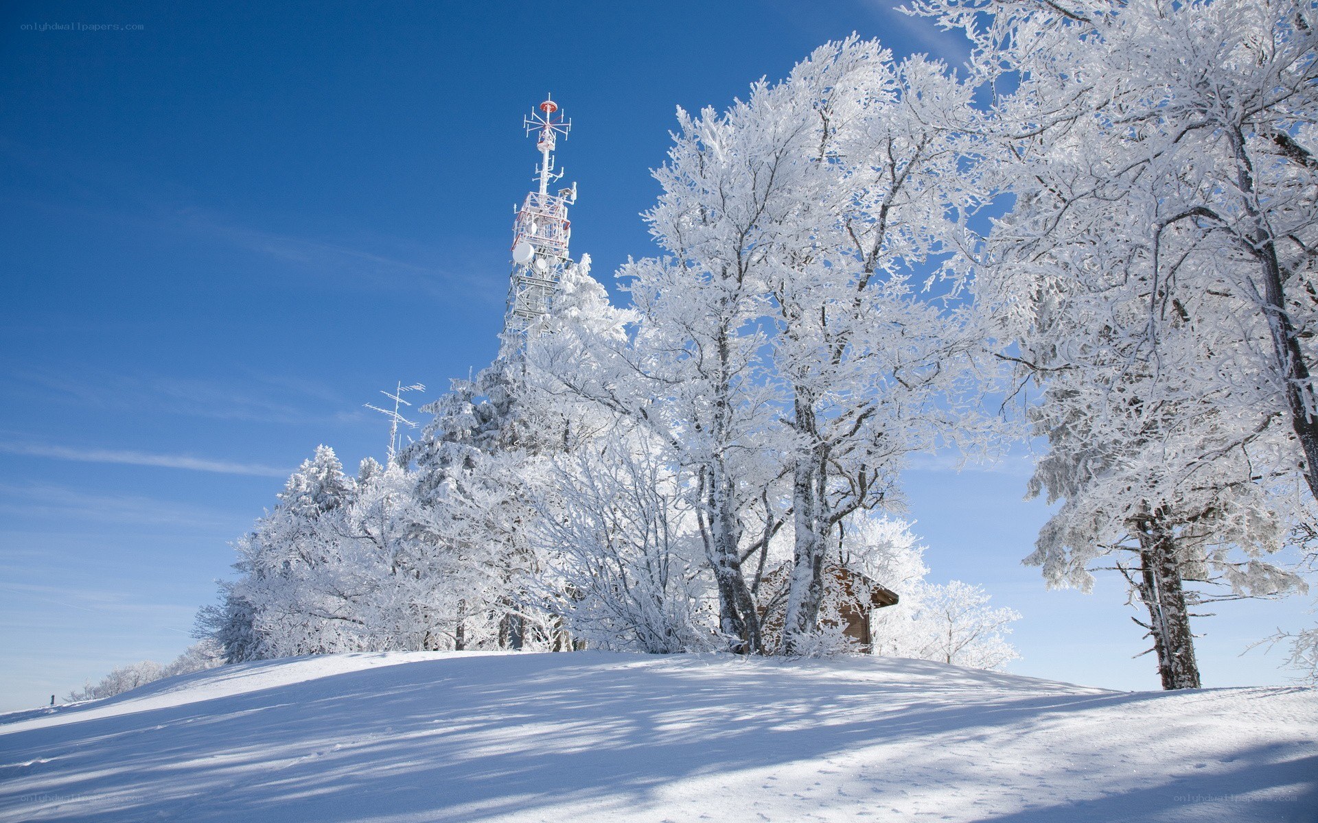 Snow-covered hill with communication tower