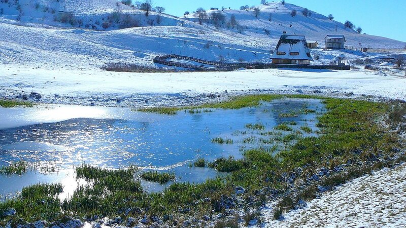 Snow-covered Hills and Pond