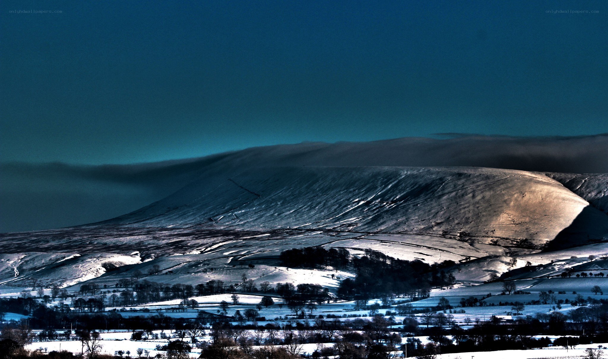 snow-covered hills at dusk