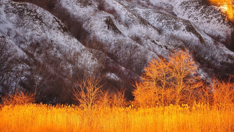 Snow-covered Hills at Sunset — Orange, Dramatic, Photograph