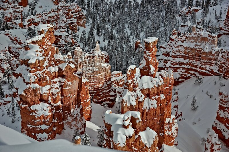 Snow-covered hoodoos in a canyon