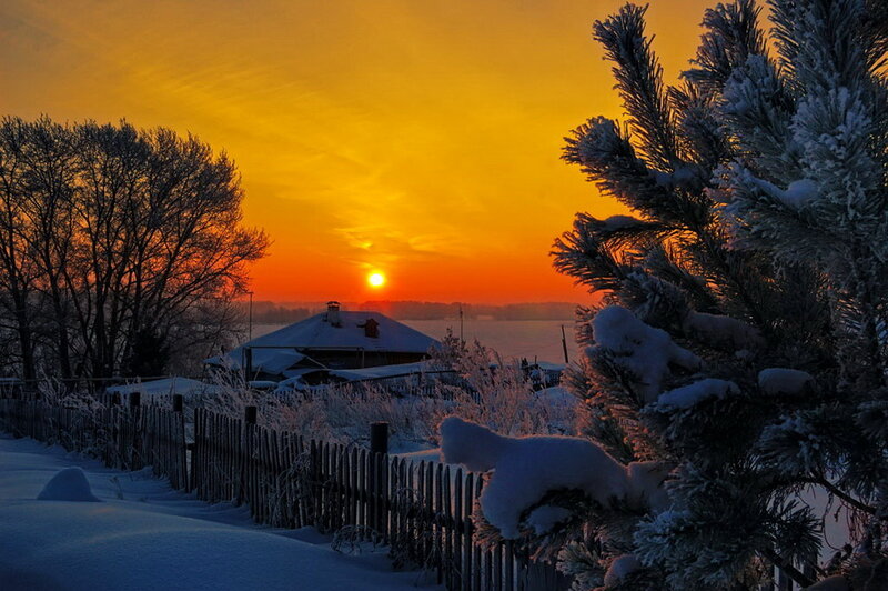 Snow-covered House at Sunset