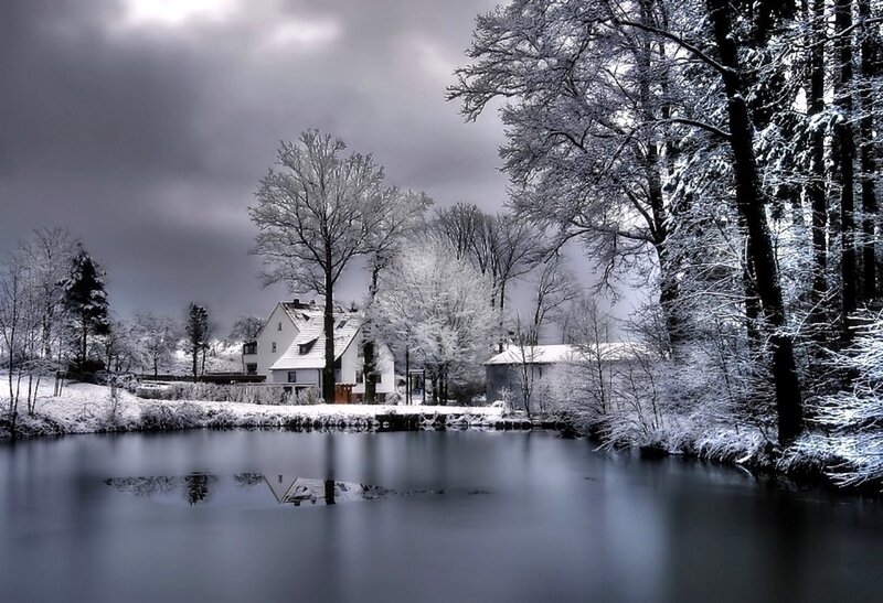 Snow-covered House by Lake