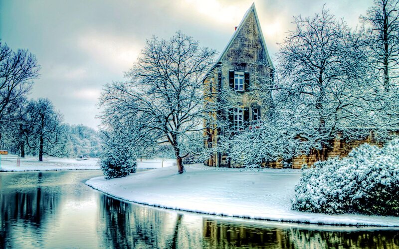 Snow-covered House by River — White