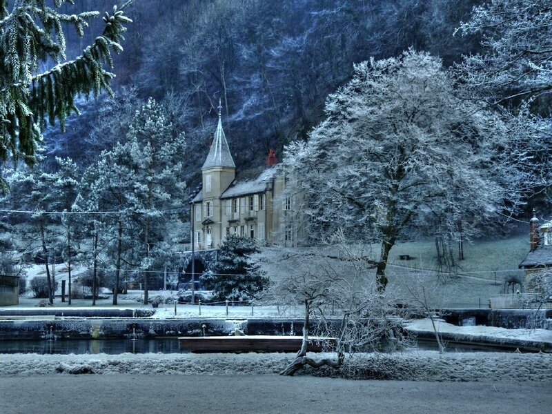Snow-covered house in winter landscape