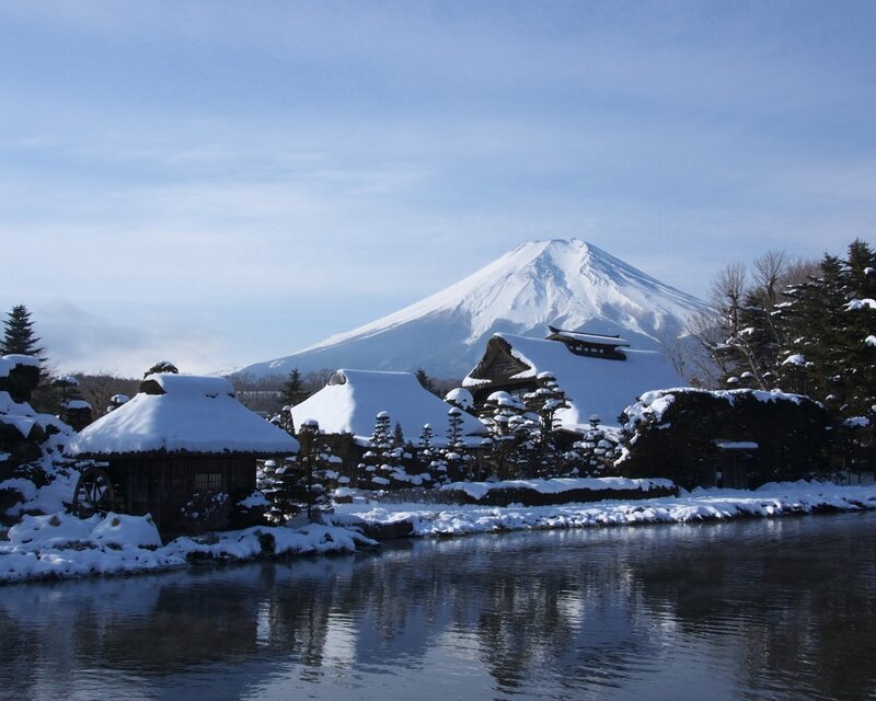 Snow-covered Houses and Mountain