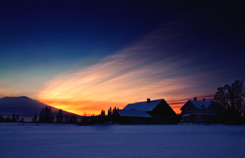 Snow-covered Houses at Sunset