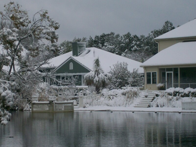 Snow-covered Houses by Water