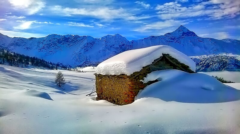 Snow-covered Hut in Mountains