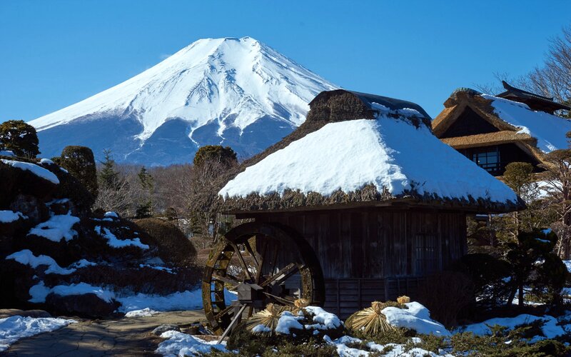 Snow-covered Hut with Waterwheel