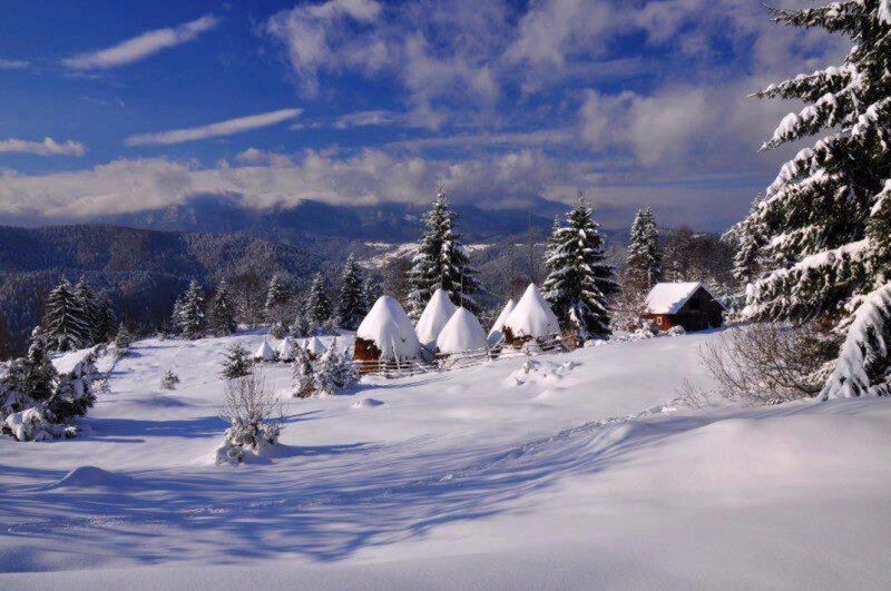 Snow-covered Huts in Mountains