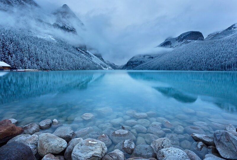 Snow-covered Lake and Mountains — Blue, Serene, Winter, Photograph, Forest, Rocks