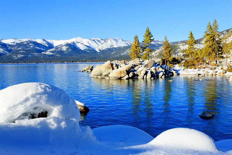 Snow-covered Lake and Mountains — Blue, Serene, Winter, Photograph, Pine Trees, Rocks