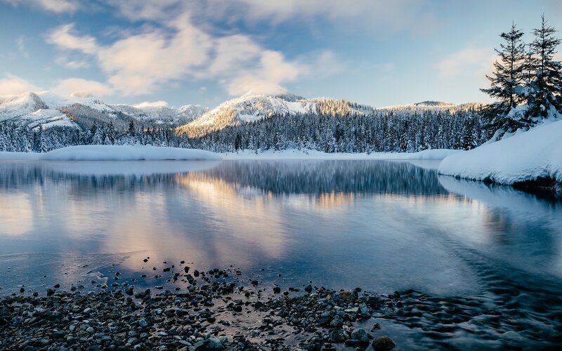 Snow-covered Lake and Mountains — Blue, Serene, Winter, Photograph, Trees, Rocks, Clouds