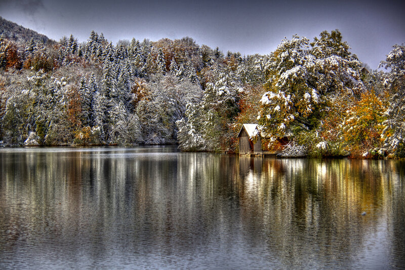 Snow-covered Lake Cabin