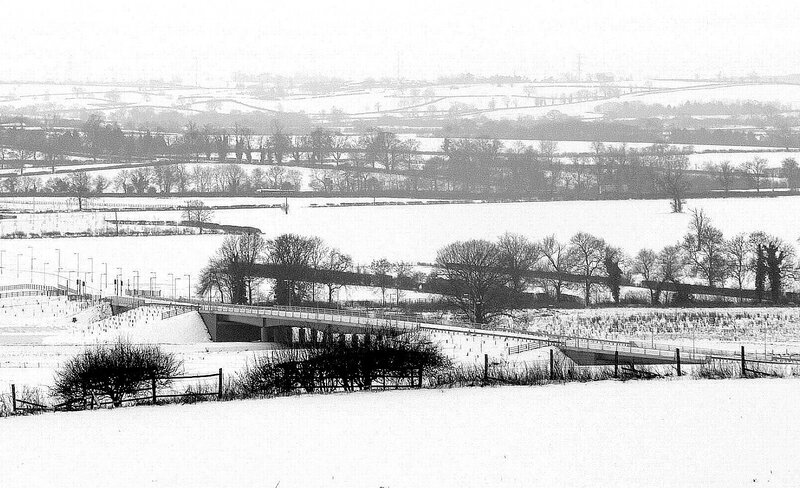 snow-covered landscape with bridge