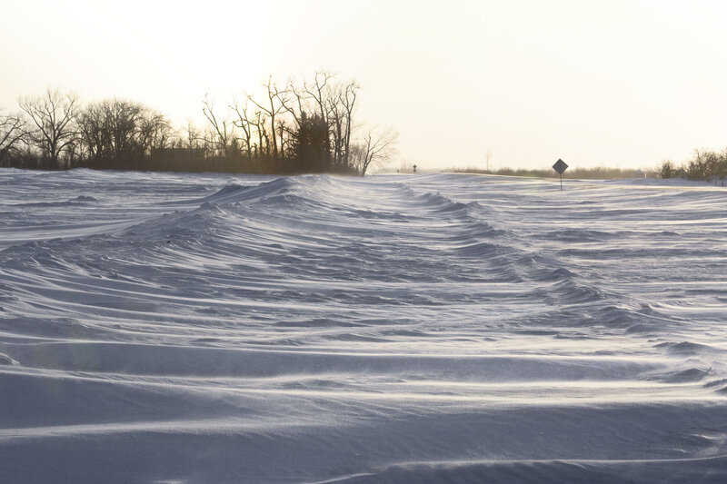 Snow-covered landscape with wind-sculpted drifts