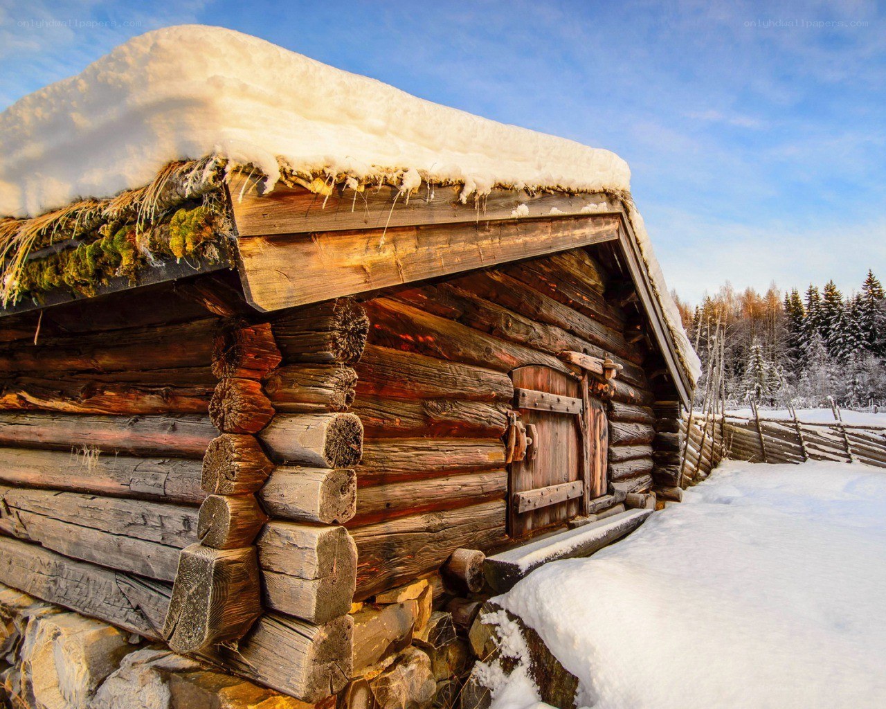 Snow-covered log cabin