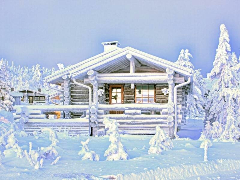 Snow-covered log cabin in winter