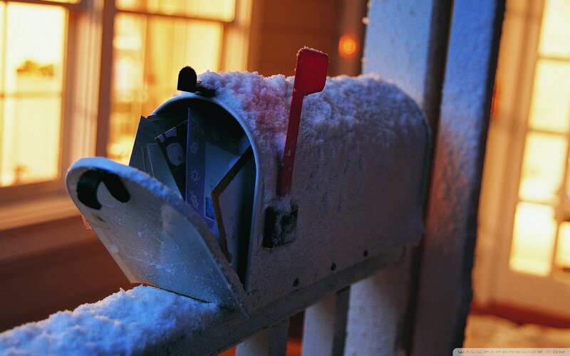 Snow-covered mailbox with mail