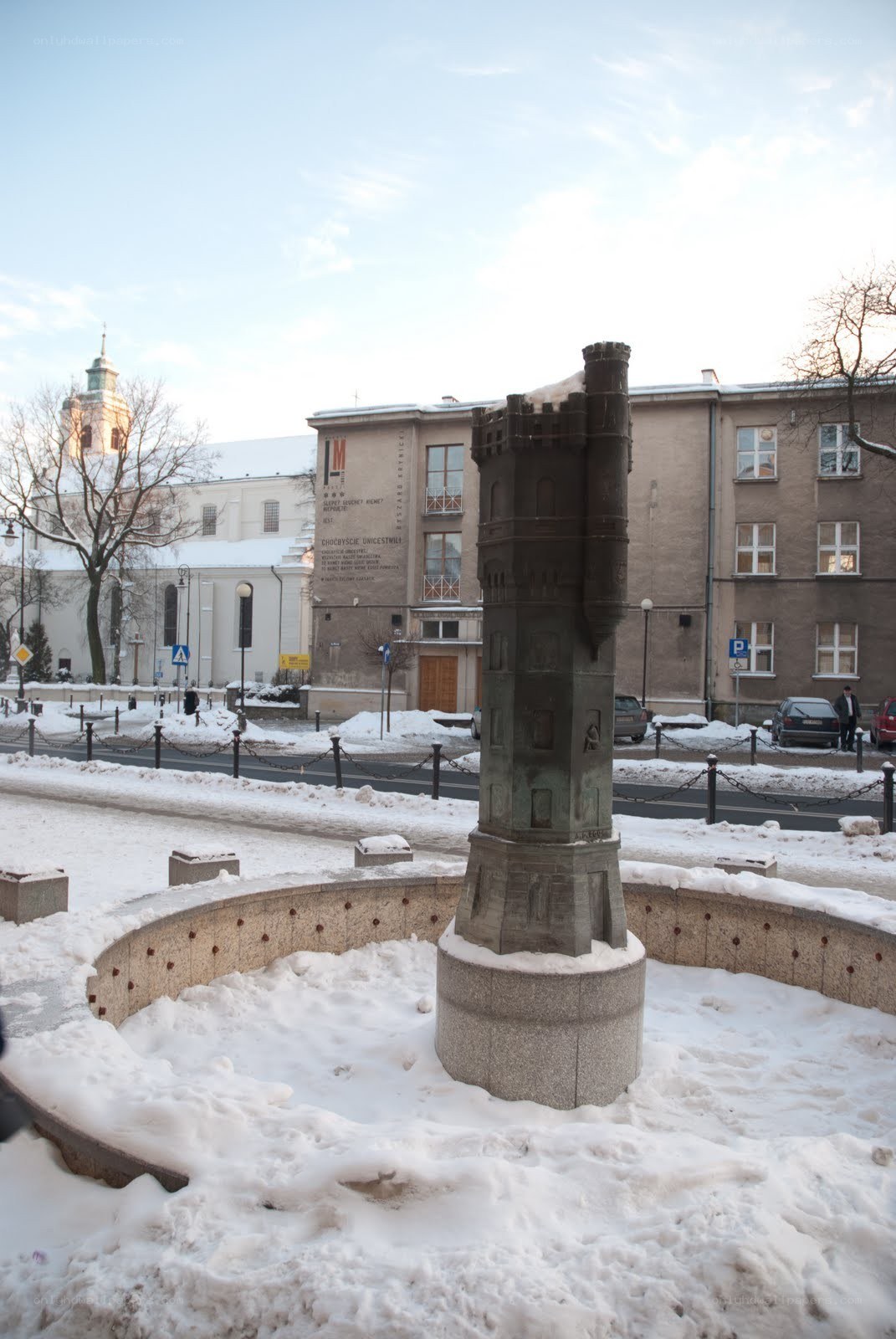 Snow-covered monument in city square