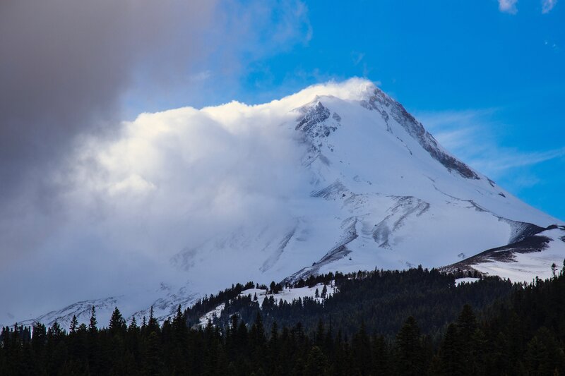Snow-covered Mountain Peak — Blue, Dramatic, Afternoon, Photograph, Clouds, Forest