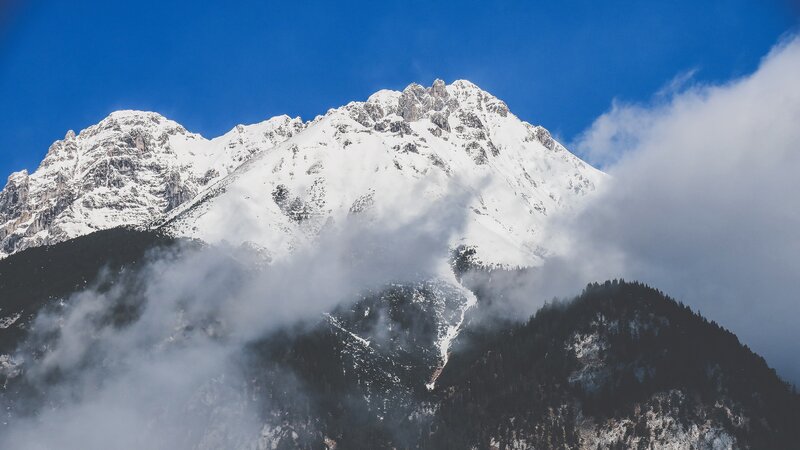 Snow-covered Mountain Peak — Blue, Dramatic, Photograph, Clouds, Forest