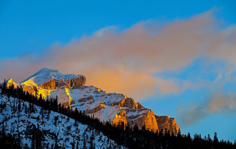 Snow-covered Mountain Peak — Blue, Dramatic, Sunrise, Photograph, Clouds, Trees, Sunlight