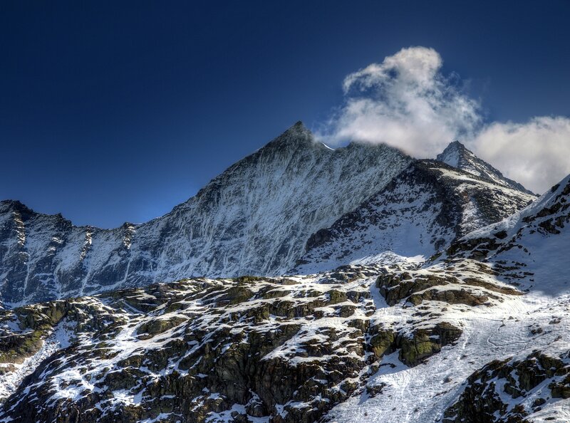 Snow-covered Mountain Peak — Blue, Dramatic, Winter, Photograph, Clouds, Rocky Terrain