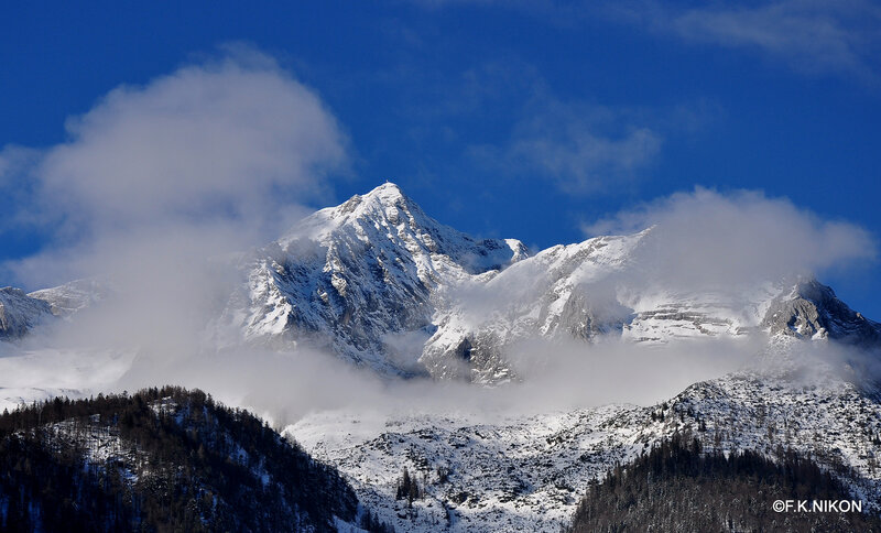 Snow-covered Mountain Peak — Blue, Dramatic, Winter, Photograph, Clouds, Trees