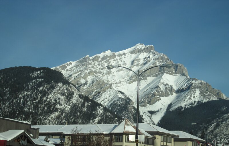 Snow-covered Mountain Peak — Blue, Serene, Winter, Photograph, Buildings