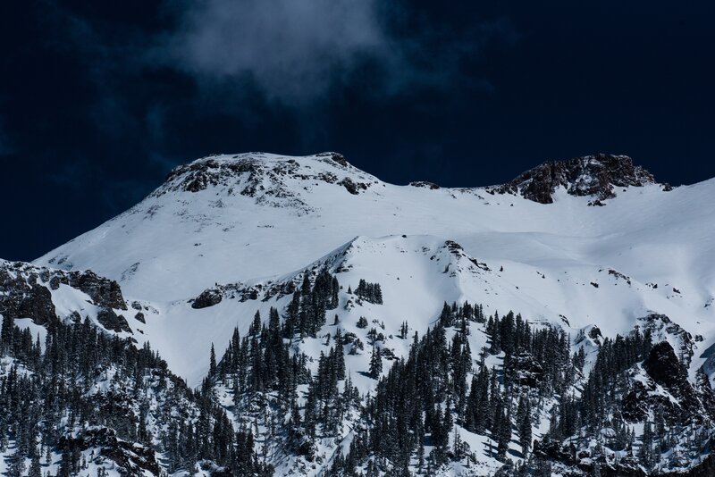 Snow-covered Mountain Peak — White, Dramatic, Night, Photograph, Trees, Rocks