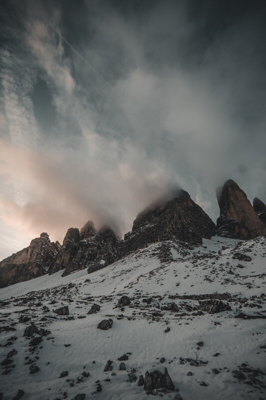 Snow-covered Mountain Peaks — Gray, Dramatic, Winter, Photograph, Clouds, Rocks