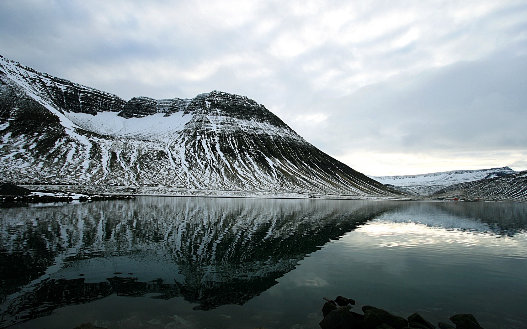 snow-covered mountain reflected in lake