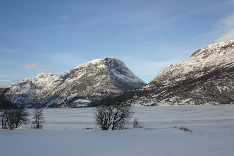 snow-covered mountains and frozen lake