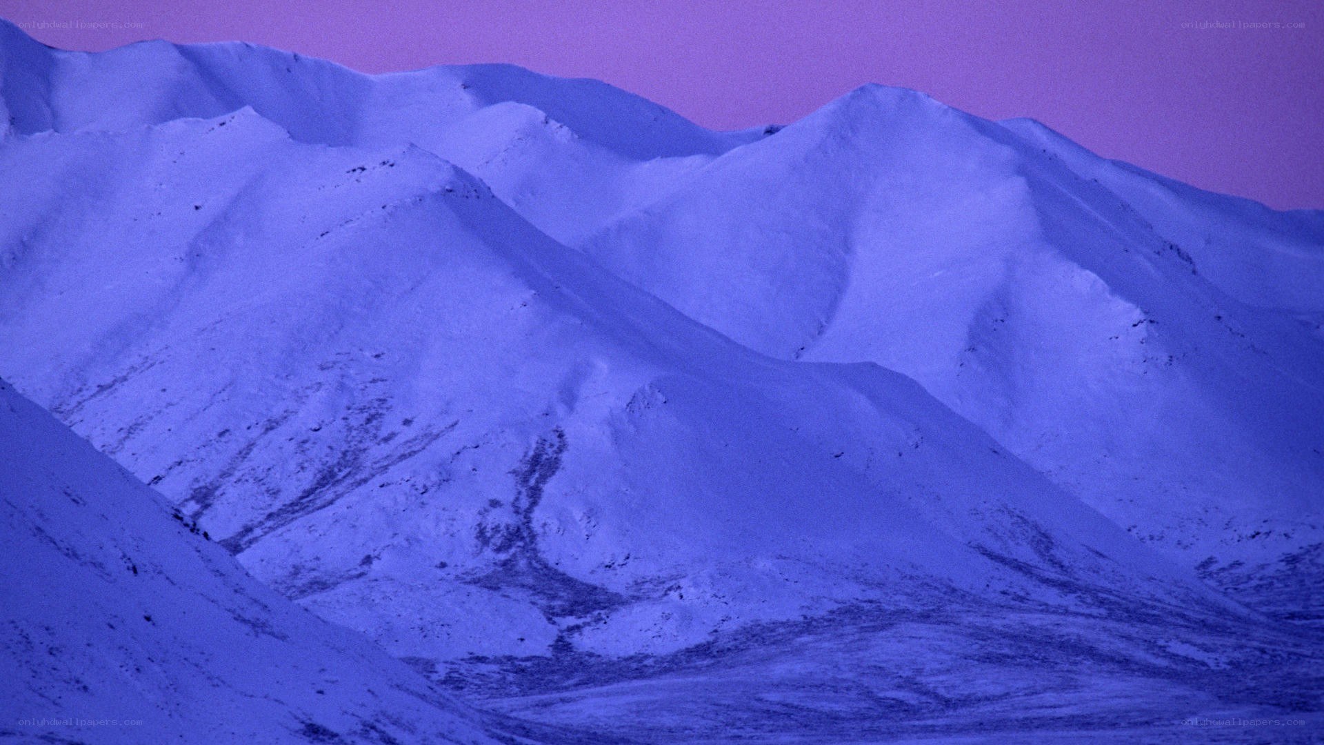 snow-covered mountains at dusk