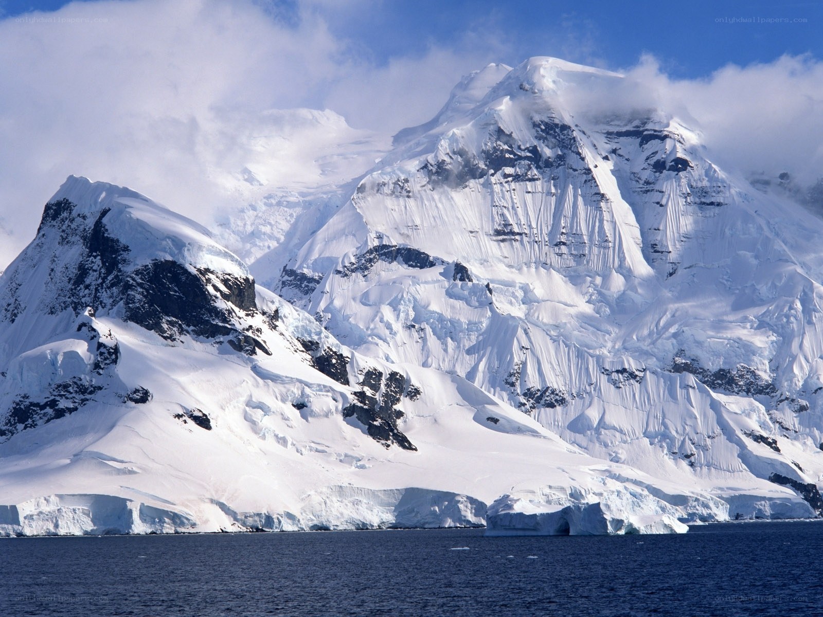 snow-covered mountains by the sea